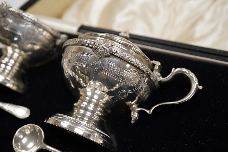 A cased six piece silver condiment set by Finnegans, Ltd, Birmingham, 1940, together with four earlier matched silver condiment spoons by Adie Brothers, 20oz.